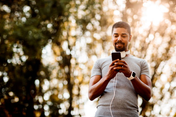 istock Sportsman texting on smartphone 1053860974