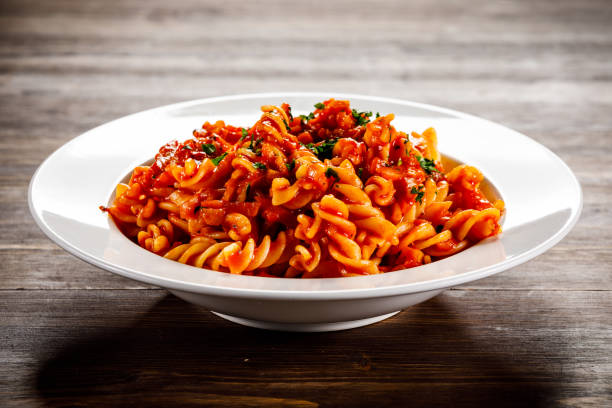 Pasta with meat tomato sauce and vegetables Pasta with meat and vegetables fusilli stock pictures, royalty-free photos & images