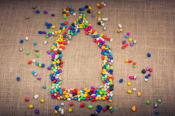istock House form shaped by colorful pebbles 1053876360