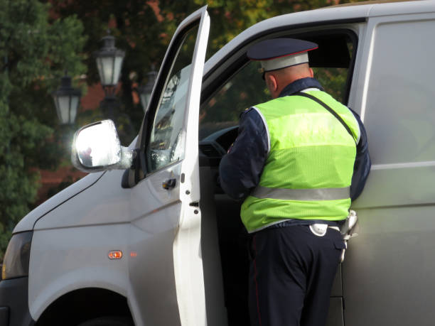 traffic cop checks the documents of the car driver, road accident - rules of the road imagens e fotografias de stock