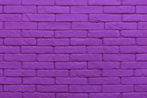 istock ultraviolet brick wall painted at saturated purple colour 1053882456