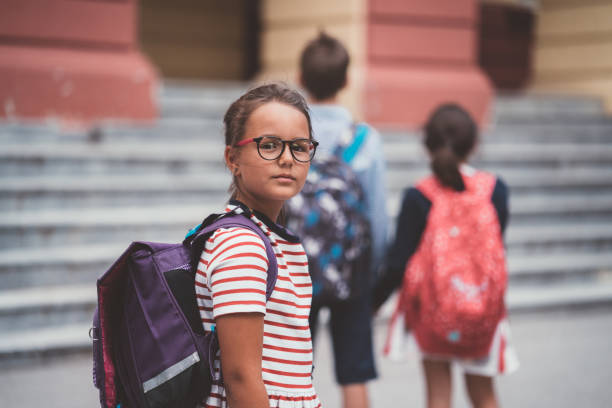 istock Schoolgirl looking at camera,back to school concept 1053883186