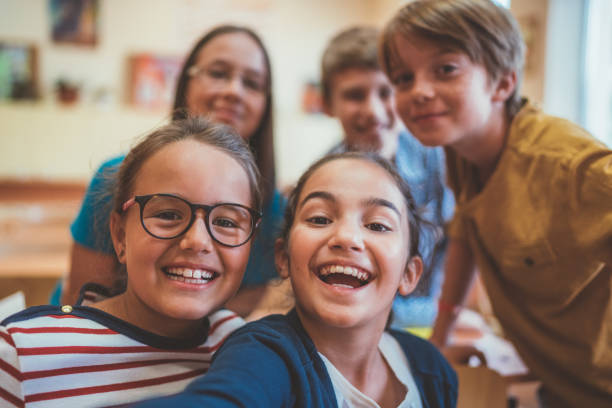 istock School children taking selfie in class 1053883410