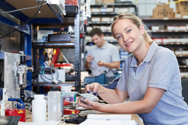 istock Portrait Of Female Engineer In Factory Measuring Component At Work Bench Using Micrometer 1053889916