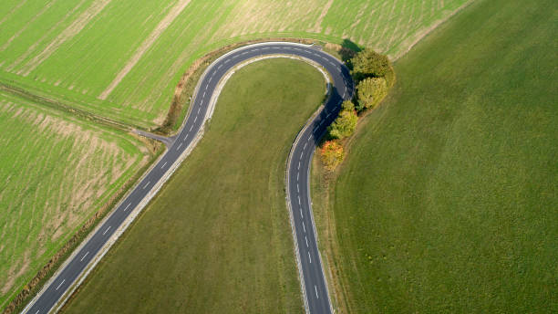 istock Road curve - agricultural area 1053892032