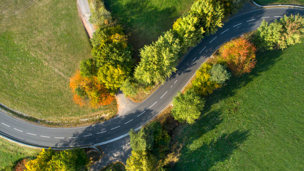 istock Road through rural scene, aerial view 1053892434