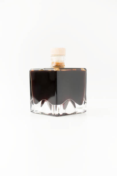 istock Balsamic Vinegar of Modena in Square Glass Bottles on White 1053901232