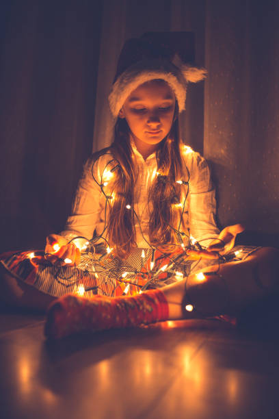 istock Girl holding Christmas string lights 1053901336