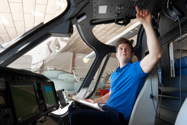 istock Male Aero Engineer With Clipboard Working In Helicopter Cockpit 1053905774