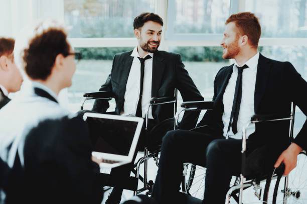 istock Disabled People in Business Suits in Bright Room. 1053909332
