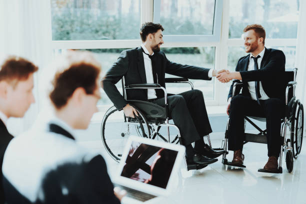 istock Greeting Two Friends Disabled in Business Suits. 1053909396