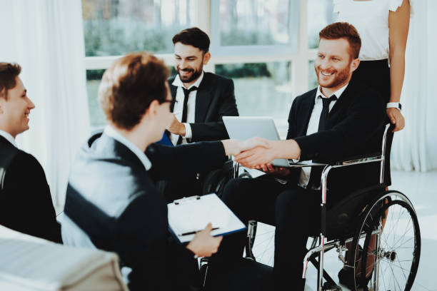 istock Four Young Mans Disabled in Wheelchair with Laptop 1053909416