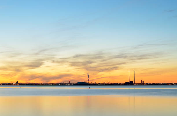 Dublin bay,Ireland,on a windless evening,calm sea and an orange hue in the sky. stock photo