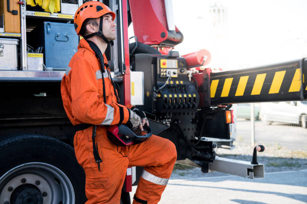 istock Firefighters in a rescue operation - operating a crane, construction machinery 1053913612