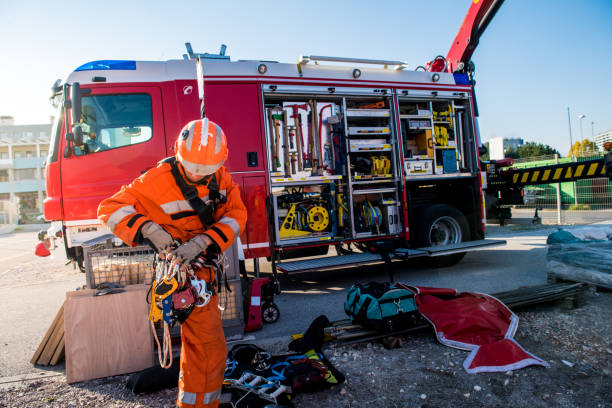 istock Firefighters in a rescue operation - preparing by a fire truck 1053916186