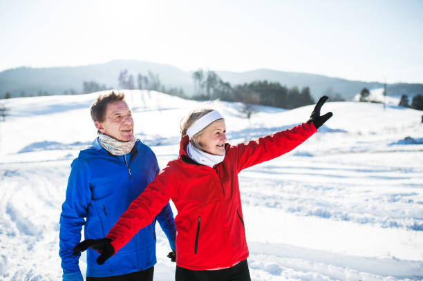 istock Senior couple runners standing in winter nature, resting. 1053918110
