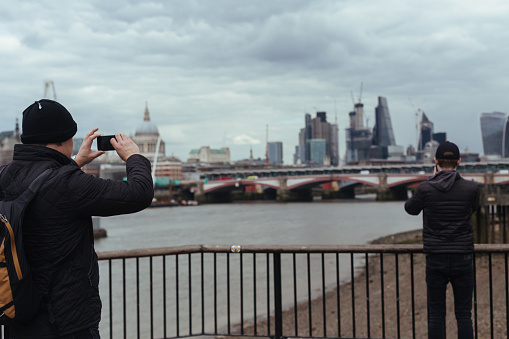London/UK - March 25 2018: Tourists taking photos of London from the Sout Bank of Thames River