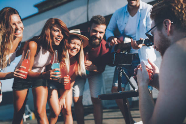 istock Group of happy friends having party on rooftop 1053918638