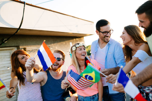 istock Group of happy friends having party on rooftop 1053918668