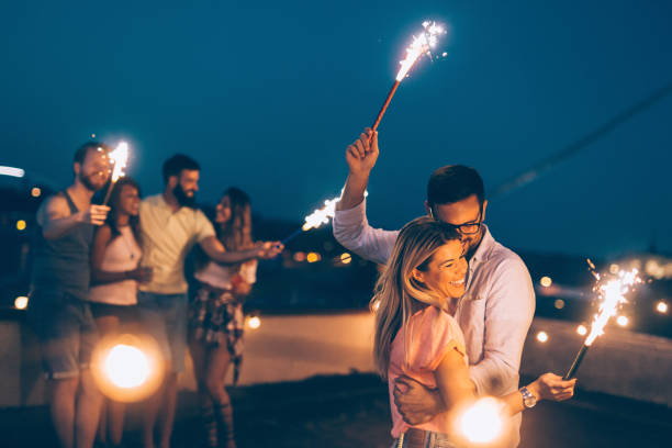 istock Group of happy friends celebrating at rooftop 1053918772