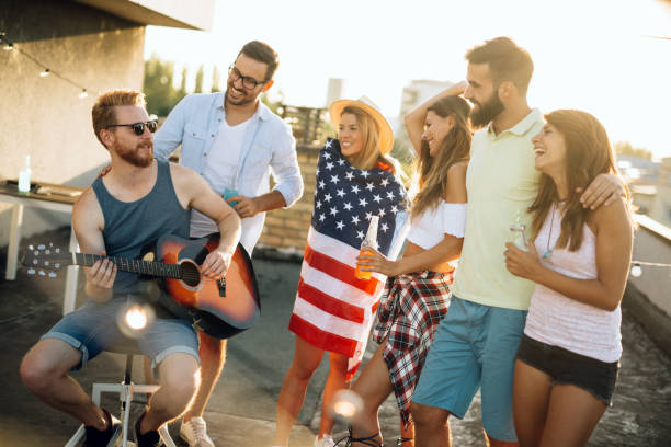 istock Group of happy friends having party on rooftop 1053918788