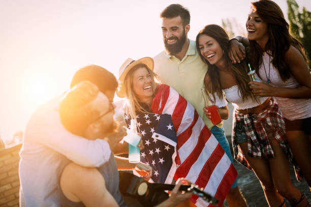 istock Group of happy friends having party on rooftop 1053918794