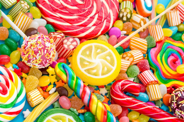 istock Colorful lollipops and different colored round candy. Top view. 1053923322