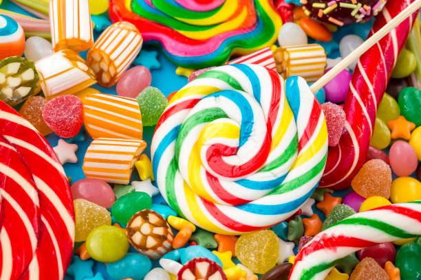 istock Colorful lollipops and different colored round candy. Top view. 1053923476