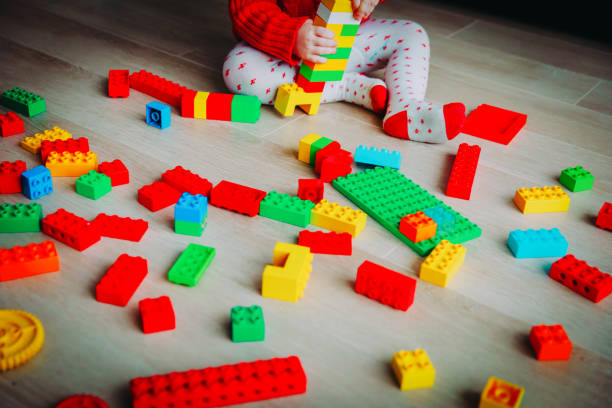 istock little baby playing with colorful plastic blocks 1053925122