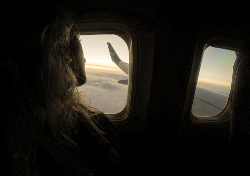 Girl who looking from window airplane