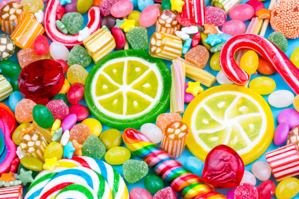 istock Colorful lollipops and different colored round candy. Top view. 1053925916