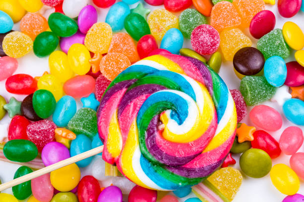 istock Colorful lollipops and different colored round candy. Top view. 1053927358