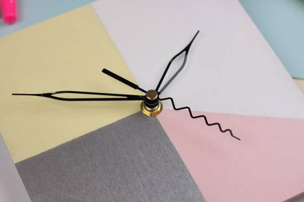 Creative bright top view with wall clock on the pink and blue background. Flat lay