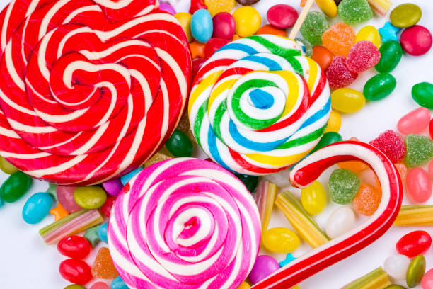istock Colorful lollipops and different colored round candy. Top view. 1053928138