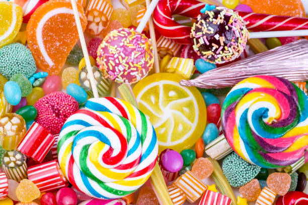 istock Colorful lollipops and different colored round candy. Top view. 1053929842