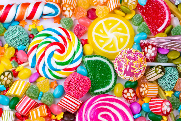istock Colorful lollipops and different colored round candy. Top view. 1053930002