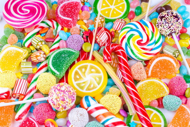istock Colorful lollipops and different colored round candy. Top view. 1053930024