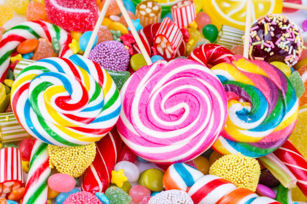 istock Colorful lollipops and different colored round candy. Top view. 1053930044