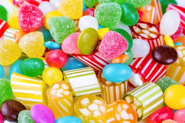 istock Colorful lollipops and different colored round candy. Top view. 1053930100