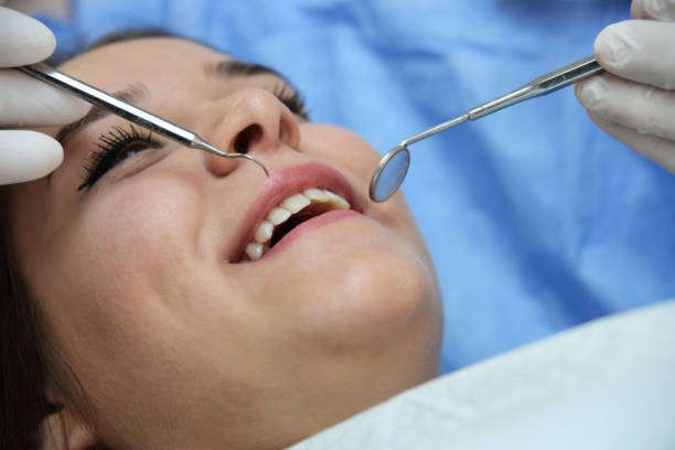 istock Young confident woman at dentist for routine checkup 1053930396
