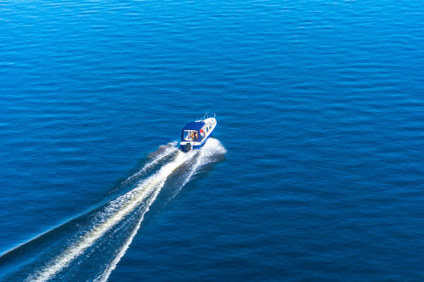 istock Speedboat sailing on the sea - top view 1053930452