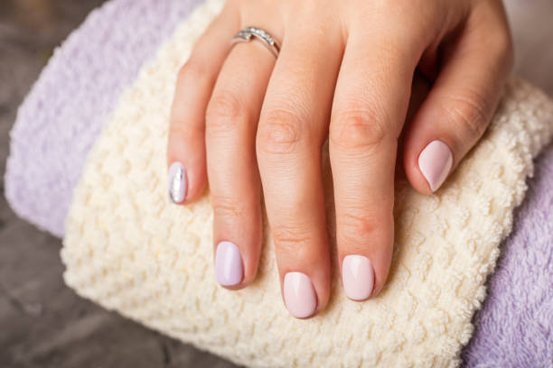 istock Beautiful hands with pink manicure 1053930832