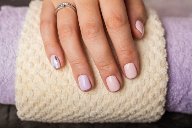 istock Beautiful hands with pink manicure 1053930852