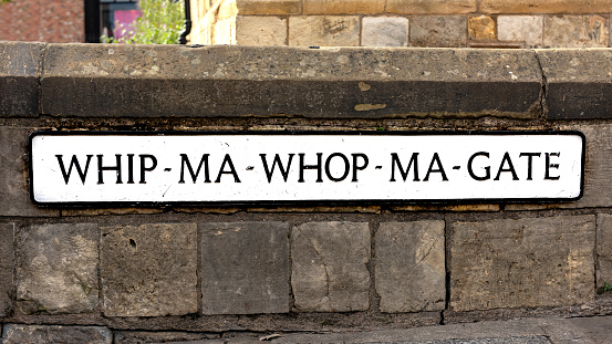 Street sign close up of the unusually-named street of Whip-Ma-Whop-Ma-Gate in York, England.