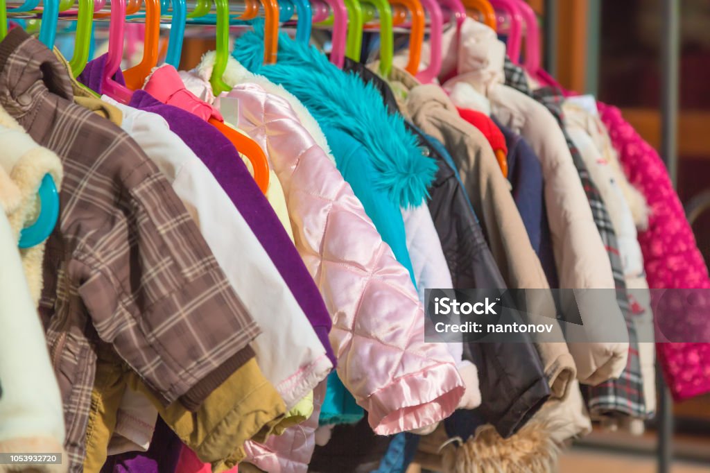 Rack of baby and children used dress, clothes displayed at outdoor hanger market for sale. Rack of baby and children used dress, clothes displayed at outdoor hanger market for sale Donation Box Stock Photo