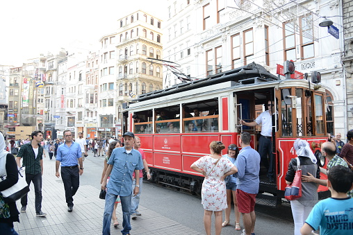 Istanbul, Turkey - August 10, 2014: Nostalgic Tram passing through Istiklal Avenue.