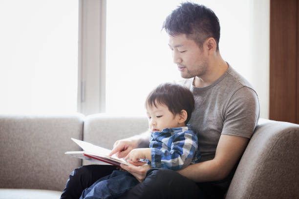 istock Father and son reading a book together 1053936458