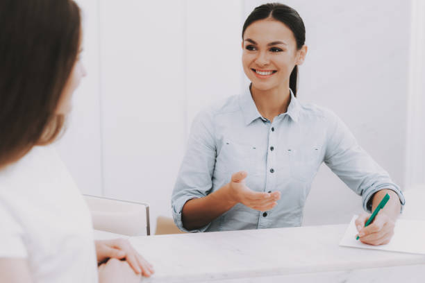 istock Smiling Employee Talking Client in Beauty Salon. 1053938182