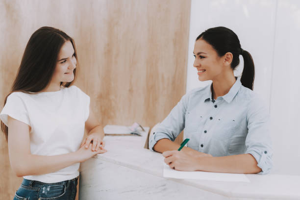 istock Woman Receptionist with Client in Beauty Salon. 1053938184