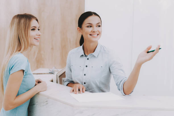 istock Smiling Womans at White Reception in Beauty Salon. 1053938192